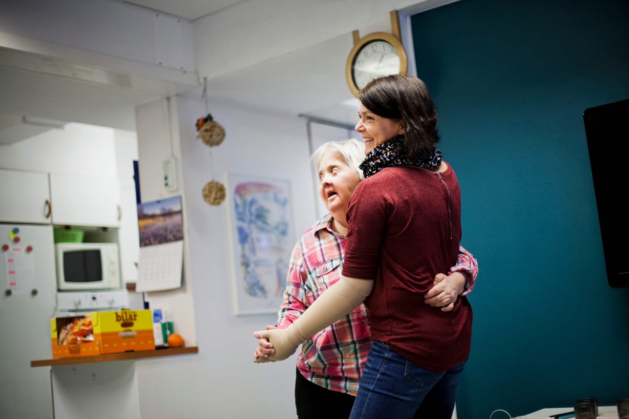 Mentally challenged woman dancing with caregiver at home
