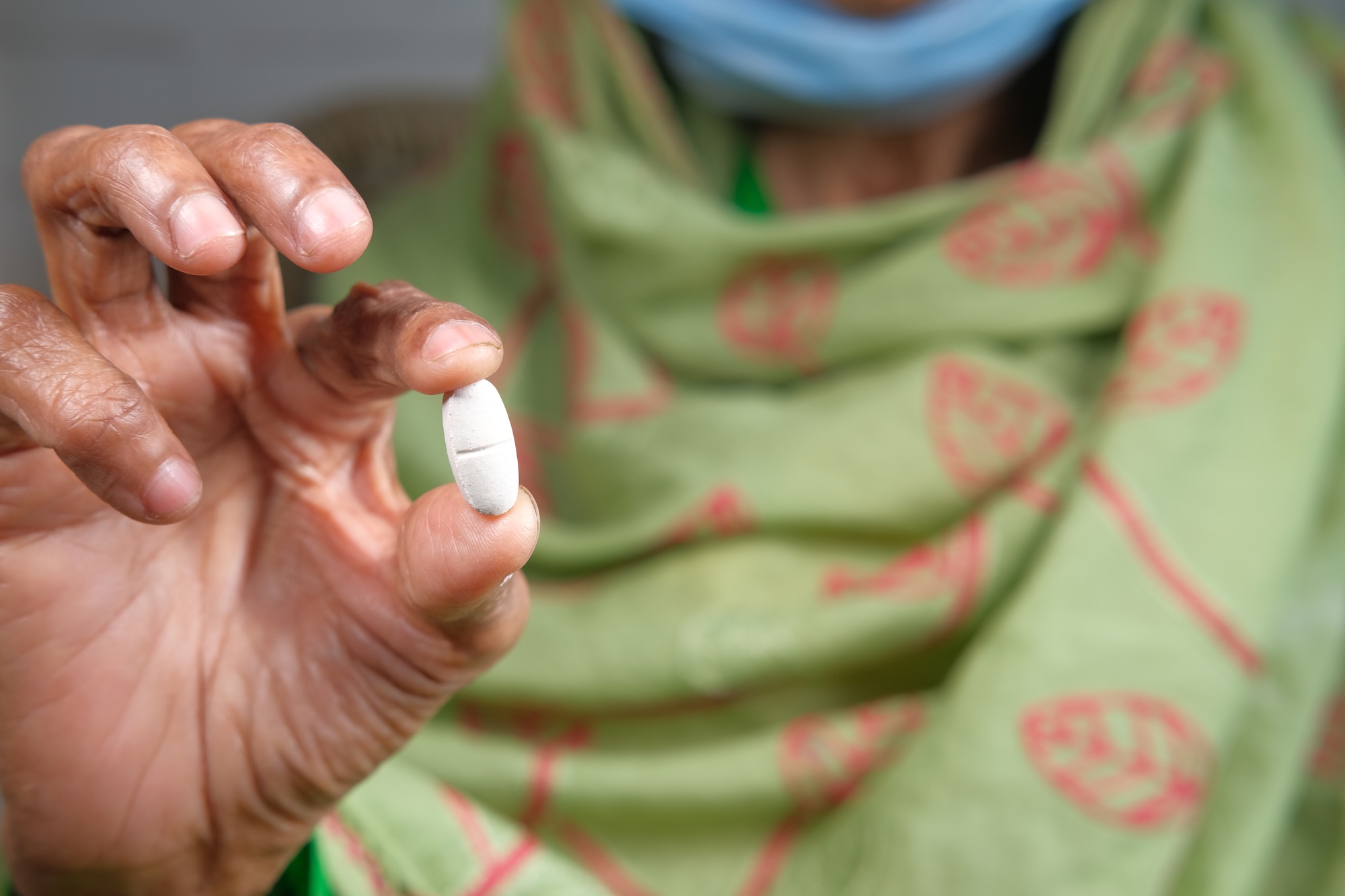 senior hand holding pills with copy space
