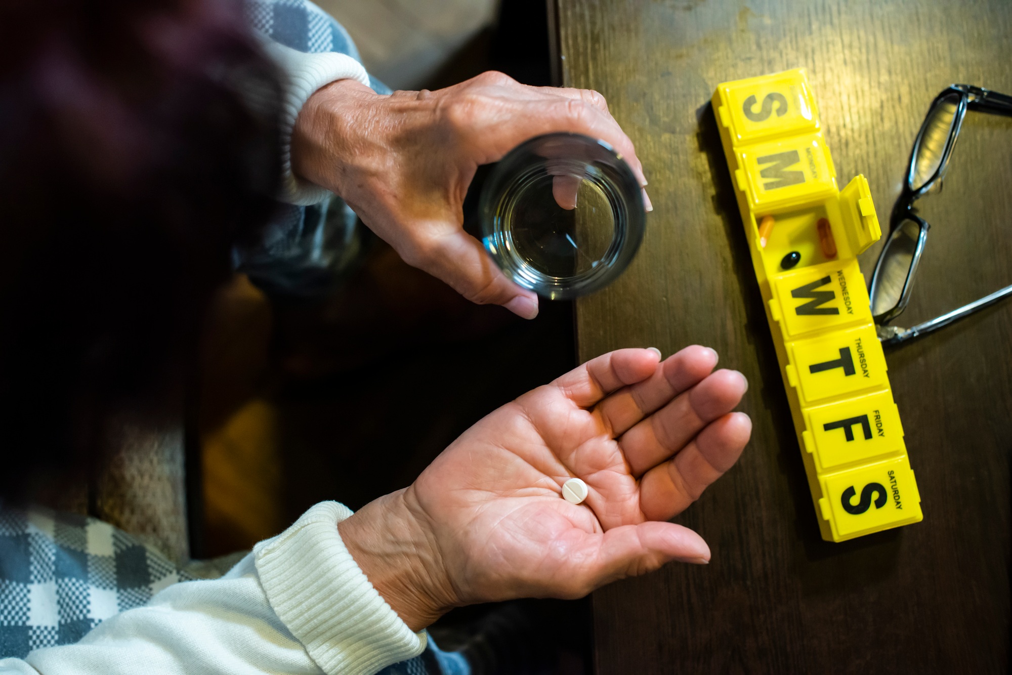 Senior woman take pills from box. Healthcare and old age concept