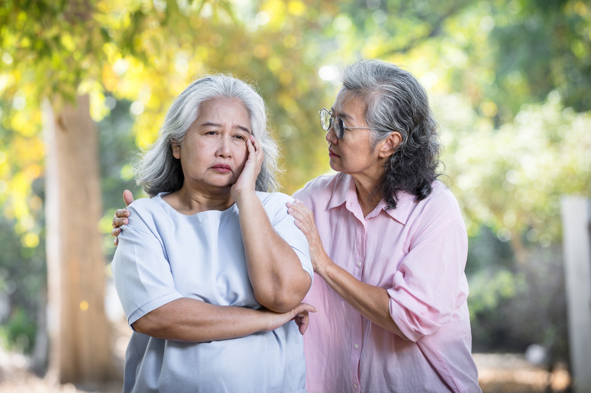 Senior women touching shoulder comforting senior friend.Quality of Friendship concept.
