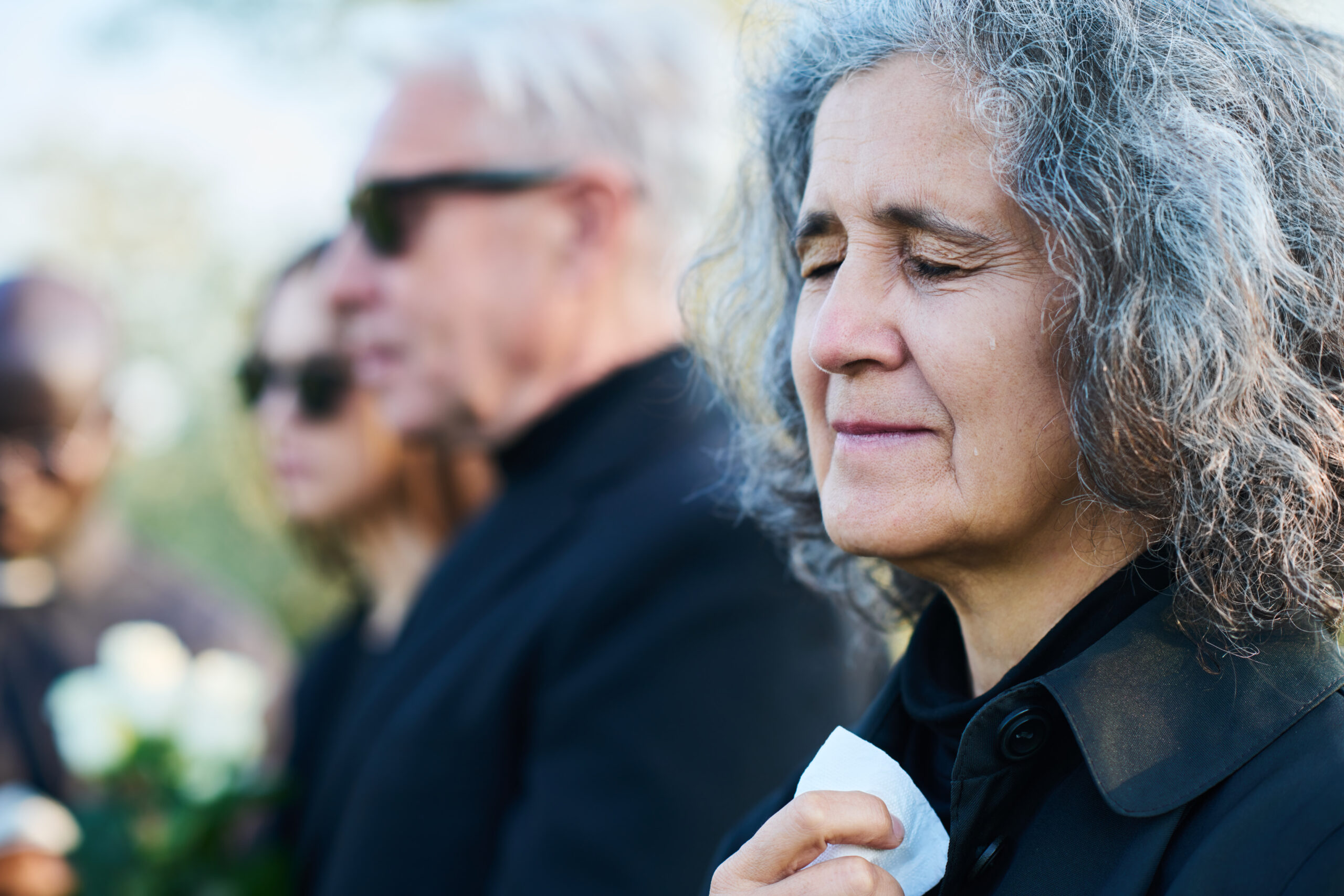 Elderly grieving at funeral