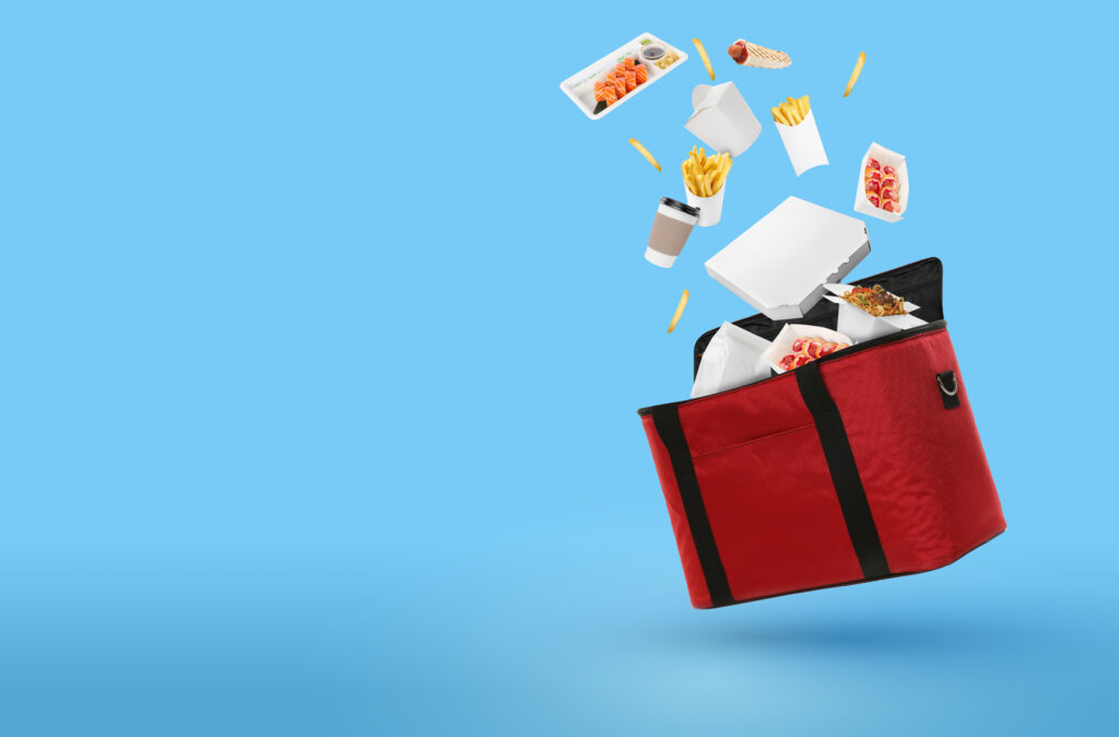 food floating out of a red delivery bag