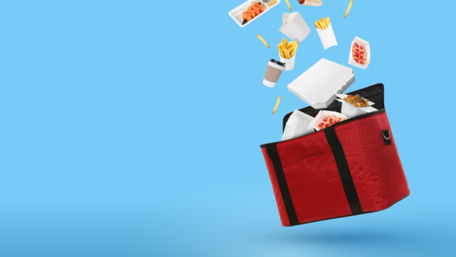 food floating out of a red delivery bag